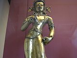 British Museum Top 20 Buddhism 16-1 Vajrasattva 16. Vajrasattva � Nepal, 15C AD, 52cm high. The gilded bronze standing figure holds the vajra and bell in his hands, has elaborate jewelry, and is inset with semi-precious stones. In Vajrasattva's crown is the seated figure of the Akshobhya, the Tathagata Meditation Buddha of the East.